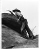 1920s cowboy among rocks aiming revolver by Anonymous