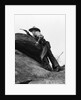 1920s cowboy among rocks aiming revolver by Anonymous