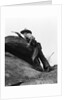 1920s cowboy among rocks aiming revolver by Anonymous