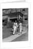 1930s couple walking out of house down sidewalk carrying picnic baskets & thermos jug by Anonymous