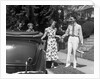 1930s family of four getting into convertible automobile with picnic basket and thermos jug by Anonymous