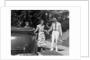 1930s family of four getting into convertible automobile with picnic basket and thermos jug by Anonymous