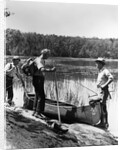1930s three fishermen standing beside canoe holding fishing gear net backpack lake of the woods ontario by Anonymous
