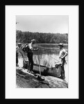 1930s three fishermen standing beside canoe holding fishing gear net backpack lake of the woods ontario by Anonymous
