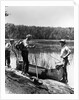 1930s three fishermen standing beside canoe holding fishing gear net backpack lake of the woods ontario by Anonymous