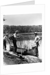 1930s three fishermen standing beside canoe holding fishing gear net backpack lake of the woods ontario by Anonymous