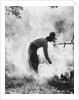 1920s 1930s man cowboy cook bending over campfire by Anonymous