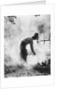 1920s 1930s man cowboy cook bending over campfire by Anonymous
