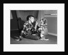 1950s boy in plaid shirt shaking finger at dog sitting up on rear legs by Anonymous