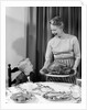 1960s grandmother grandson roast turkey thanksgiving dinner by Anonymous