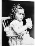1930s child girl sitting in high chair holding glass of milk serious look bow in hair baloney curls by Anonymous