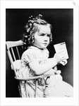 1930s child girl sitting in high chair holding glass of milk serious look bow in hair baloney curls by Anonymous
