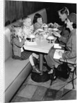 1950s family eating ice cream at a diner by Anonymous