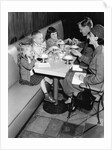 1950s family eating ice cream at a diner by Anonymous