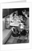 1950s family eating ice cream at a diner by Anonymous