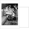 1950s family eating ice cream at a diner by Anonymous