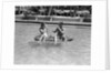 1930s 1940s couple drinking while floating in a pool on a rubber raft at florida resort by Anonymous