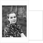 1930s portrait of brunette woman wearing printed blouse half smile mona lisa like beautiful eyes looking at camera by Anonymous