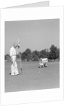 1930s 1940s elderly men on golf green one holding flag the other kneels lining up his putt by Anonymous