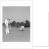 1930s 1940s elderly men on golf green one holding flag the other kneels lining up his putt by Anonymous