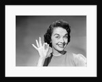 1950s woman smiling wearing pearl necklace looking at camera making okay gesture with hand by Anonymous