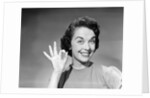 1950s woman smiling wearing pearl necklace looking at camera making okay gesture with hand by Anonymous