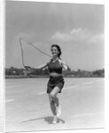 1930s woman jumping rope exercise outdoors wearing polka dot halter top and shorts by Anonymous