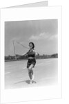 1930s woman jumping rope exercise outdoors wearing polka dot halter top and shorts by Anonymous