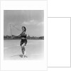 1930s woman jumping rope exercise outdoors wearing polka dot halter top and shorts by Anonymous