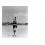 1930s woman jumping rope exercise outdoors wearing polka dot halter top and shorts by Anonymous