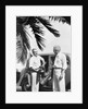 1930s 2 elderly men standing by car carrying golf bag palm tree frond in corner by Anonymous