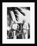 1930s 2 elderly men standing by car carrying golf bag palm tree frond in corner by Anonymous