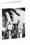 1930s 2 elderly men standing by car carrying golf bag palm tree frond in corner by Anonymous