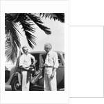 1930s 2 elderly men standing by car carrying golf bag palm tree frond in corner by Anonymous