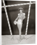 1950s 1960s woman in sexy football costume at goalpost by Anonymous