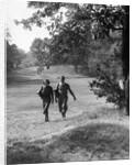 1930s couple man woman each carrying a golf bag walking down the fairway of the golf course by Anonymous