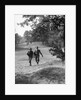 1930s couple man woman each carrying a golf bag walking down the fairway of the golf course by Anonymous
