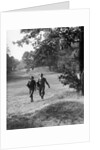 1930s couple man woman each carrying a golf bag walking down the fairway of the golf course by Anonymous