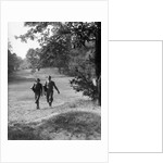 1930s couple man woman each carrying a golf bag walking down the fairway of the golf course by Anonymous