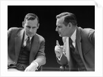 1930s 1940s businessman talking seriously to himself or his twin alter ego by Anonymous