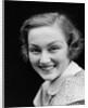 1930s portrait happy young brunette woman wearing print blouse with white collar smiling looking at camera by Anonymous