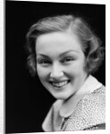 1930s portrait happy young brunette woman wearing print blouse with white collar smiling looking at camera by Anonymous