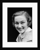 1930s portrait happy young brunette woman wearing print blouse with white collar smiling looking at camera by Anonymous