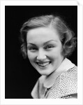 1930s portrait happy young brunette woman wearing print blouse with white collar smiling looking at camera by Anonymous