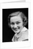 1930s portrait happy young brunette woman wearing print blouse with white collar smiling looking at camera by Anonymous
