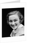 1930s portrait happy young brunette woman wearing print blouse with white collar smiling looking at camera by Anonymous