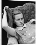 1930s woman sitting slumped position with a worried expression and a furrowed brow by Anonymous