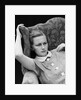 1930s woman sitting slumped position with a worried expression and a furrowed brow by Anonymous