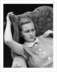1930s woman sitting slumped position with a worried expression and a furrowed brow by Anonymous