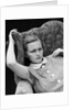 1930s woman sitting slumped position with a worried expression and a furrowed brow by Anonymous